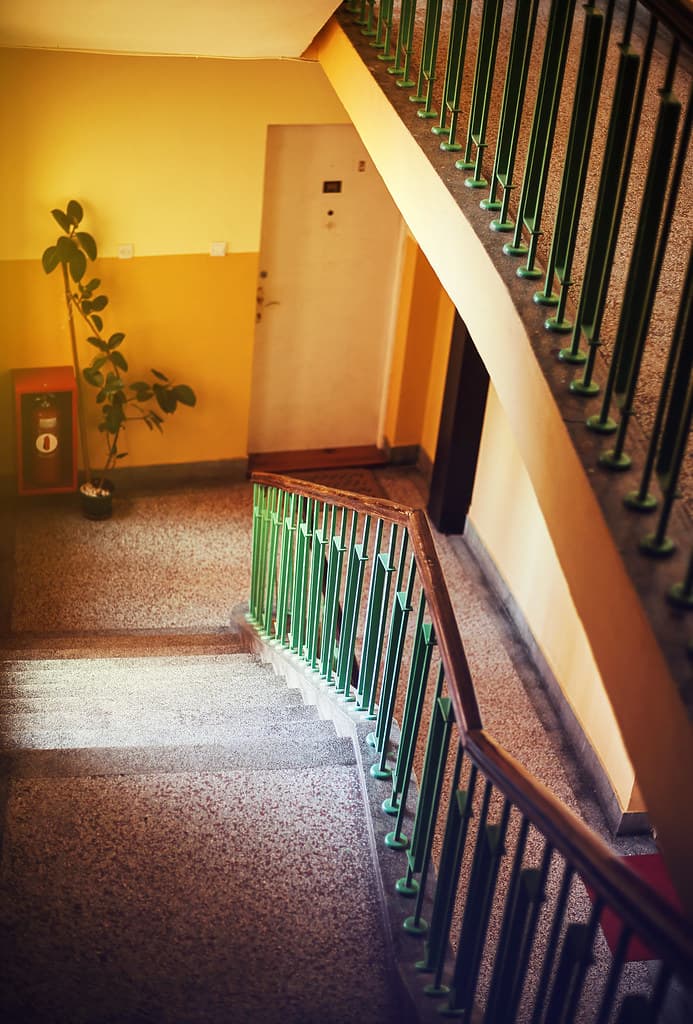 Stairwell and hallway inside an apartment building — representative photo